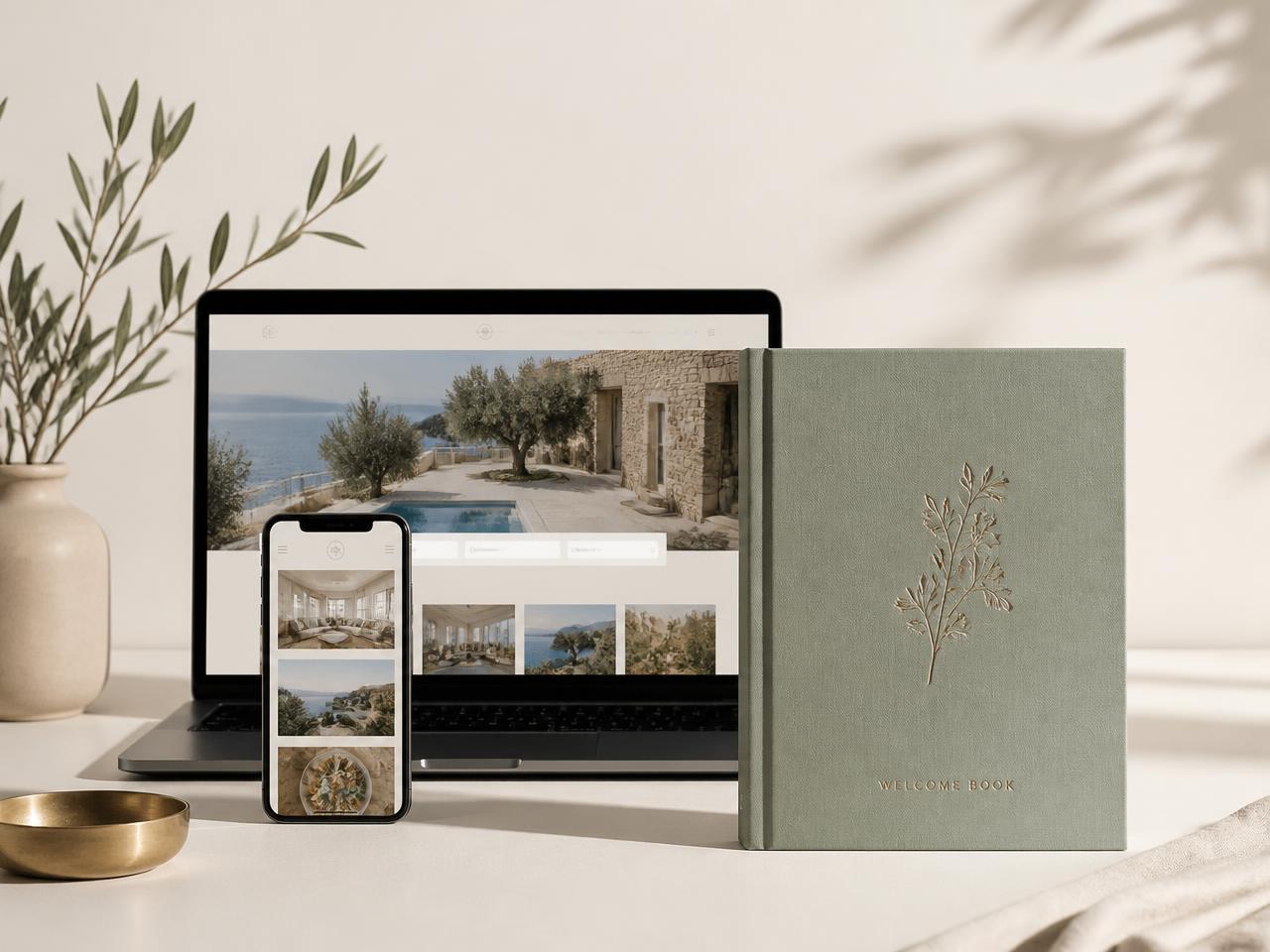A StayLore guest guide shown on a phone and laptop beside a printed welcome book